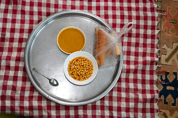 Traditional Turkish floor table with organic lentil soup, chickpeas and bread in plastic bag, authentic village food for wellness and harmony, natural eco lifestyle background.