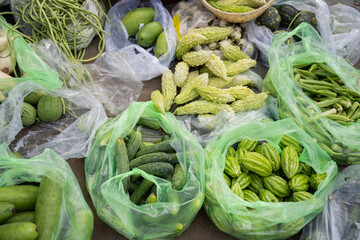 Fresh vegetables in plastic bags at Asian street market