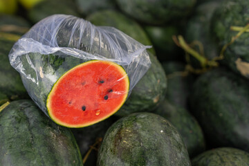 Fresh watermelons with cut slice displayed at Asian local market