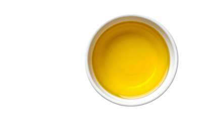 Overhead shot of a small white bowl filled with golden-yellow liquid, on black background (1)