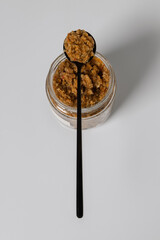 Homemade walnut and chili pepper sauce in black teaspoon