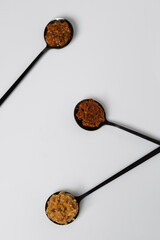 Homemade spicy chili and walnut sauce in black teaspoons