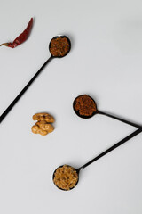 Homemade spicy chili and walnut sauce in black teaspoons