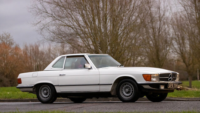 Milton Keynes,Bucks,UK - Jan 1st 2026:   1980 white Mercedes Benz 280 classic car driving on a British road