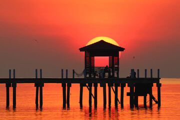The silhouette of the pavilion with a beautiful sunrise in the morning.