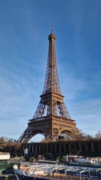 Paris, France - December 10, 2025: View from a cruising boat trip along the Seine river to the breathtaking Eiffel Tower. The iconic Parisian landmark as global attraction. French trip symbol