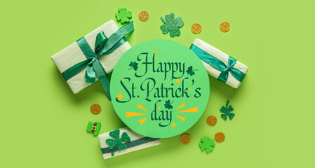 Blank card with gift boxes and decor for St. Patrick's Day celebration on green background