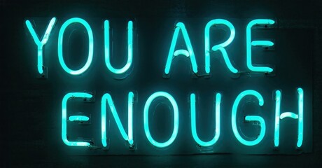 Fototapeta premium Bright neon sign displays positive message. Dark background emphasizes glowing text, offering encouragement, hope. Simple, impactful design.