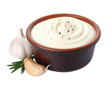 Close-up of a creamy sauce in a ceramic bowl, garnished with garlic and herbs