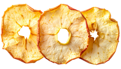 Three dried apple slices with exposed center holes, showing crisp textures and reddish edges