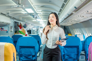 The businesswoman enjoyed her flight by listening to music with wireless headphones and using her smartphone while on the plane.