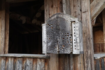 Handmade wooden insect house hanging in the garden