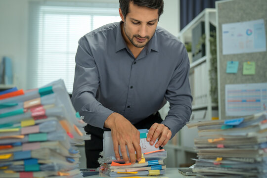 Latin executive feeling the strain of contract pressures, enduring stress and frustration as he navigates responsibilities in a demanding business environment.
