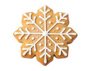 Overhead shot of a golden-brown snowflake-shaped cookie with white icing