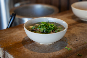 Vietnamese pho bo beef noodle soup served with fresh herbs