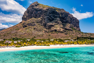 Aerial view of Le morne Brabant in Mauriutius. Tropical crystal ocean with Le Morne mountain and luxury beach in Mauritius. Le Morne beach with palm trees, white sand and luxury resorts, Mauritius.
