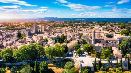Overlooking Uzes in Gard, France, this scene captures the charming stone buildings and rooftops of the city. Scenic view of Uzes city in Gard, France showcasing historic architecture. Gard, France.
