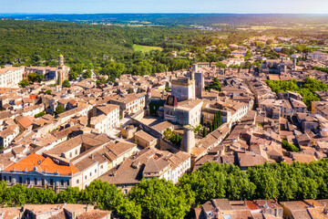 Overlooking Uzes in Gard, France, this scene captures the charming stone buildings and rooftops of the city. Scenic view of Uzes city in Gard, France showcasing historic architecture. Gard, France.
