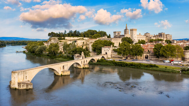 Beautiful view of Avignon with famous bridge Saint-Benezet, medieval architecture along the Rhone River in Avignon, France. The Pont Saint Benezet and the Papal palace in Avignon, South France.