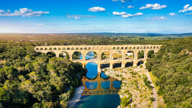 Exploring the majestic Pont du Gard aqueduct in France, discover the stunning architecture of the ancient Pont du Gard aqueduct in southern France. River Gard, Languedoc-Roussillon, France.