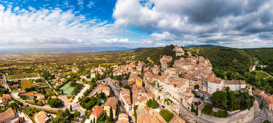Village of Bonnieux showcasing architecture and serene landscapes, Provence, Luberon, France. Stunning views of Bonnieux medieval village surrounded by lush greenery and hills in Provence.