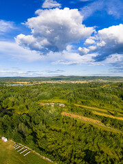 Scenic view of Tismana village in Gorj County Romania under a bright blue sky with fluffy clouds. A stunning landscape captures the beauty of Tismana village in Gorj County. Tismana, Romania.