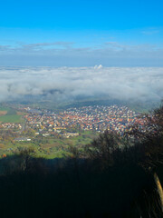 Germany, Beuren village houses roofs and buildings, foggy autumn morning aerial view above the town from above