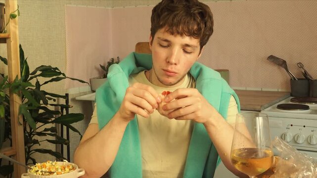 An attractive guy eats a salad for lunch.