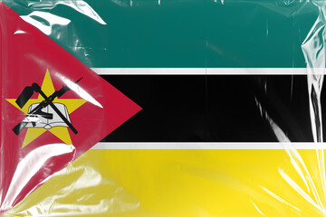 Flag of Mozambique Under Wrinkled Clear Plastic Film, Highlighting National Symbols of an Ak 47 Rifle, Hoe, and Open Book Within a Red Triangle and Yellow Star