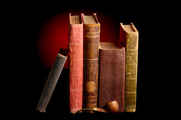 A collection of ancient books and a pipe, bathed in a warm red light, symbolizing timeless knowledge, history, and the pursuit of wisdom in a classic, scholarly setting.