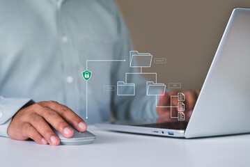 Secure digital file management system with structured folder hierarchy and document access control, showing business professional working on laptop to organize, protect, and manage enterprise data