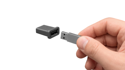 Male hand inserting silver USB flash drive into black port adapter isolated on transparent background