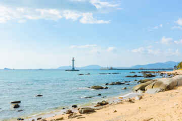White lighthouse standing on the coastal rocks at Sanya Dongtian Park (Daxiao Dongtian Scenic Area) in Sanya, Hainan, China