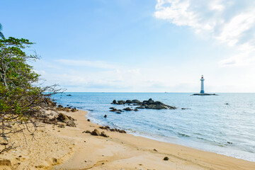 White lighthouse standing on the coastal rocks at Sanya Dongtian Park (Daxiao Dongtian Scenic Area) in Sanya, Hainan, China