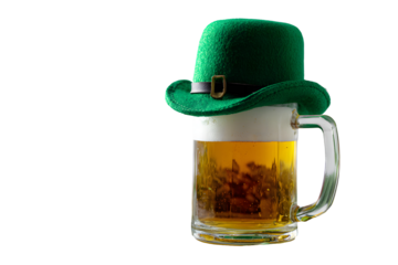 A festive green hat rests atop a tall mug of golden beer