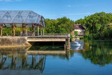 Fototapeta premium Clain river in Poitiers, modern glass structure and lush greenery