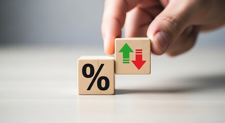 Hand positioning wooden block illustrating fluctuating percentage rates and financial market volatility