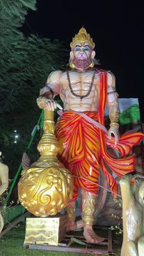 Idol of hindu god hanuman in night at temple.