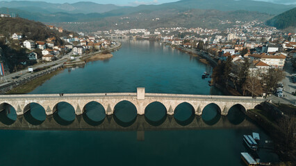 Aerial view of the historic Mehmed Pasha Sokolovic Bridge crossing the Drina River in Visegrad,...