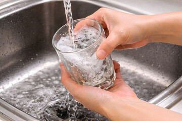 Rinsing a Glass Under Running Water