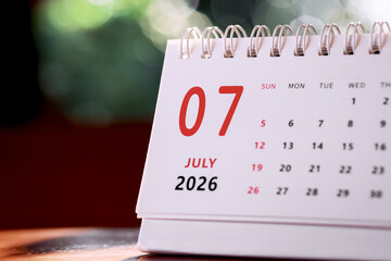 Calendar page of July 2026 on desk, with copy space. monthly planning concept, important schedules, meetings, and appointments.