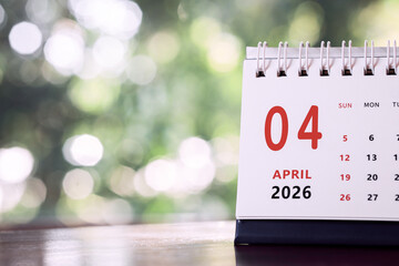 Calendar page of April 2026 on desk, with copy space. monthly planning concept, important schedules, meetings, and appointments.