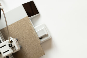 A desktop 3D printer on a white background. Modern technologies for additive manufacturing, digital education