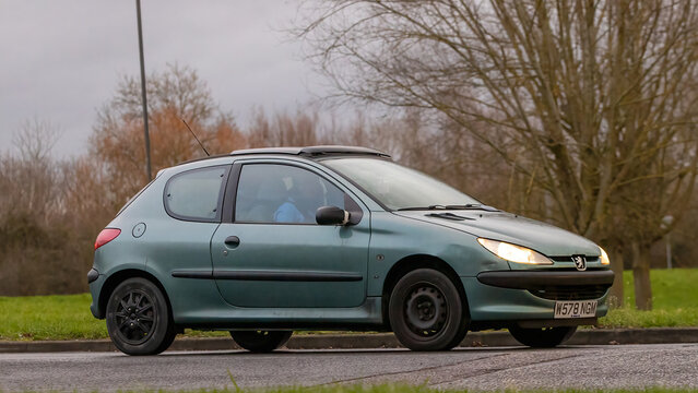 Milton Keynes,Bucks,UK - Jan 1st 2026: 2000 green Peugeot 206  classic car driving on a British road