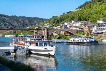 Cochem, Germany- view of the Moselle with bridge and excursion boats , summer atmosphere and cityscape