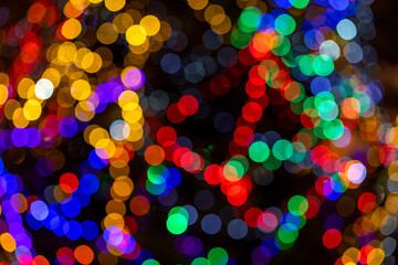 Colored abstract light background. Abstract blurred light pattern of lit candles