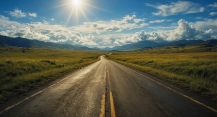 empty asphalt road leading to distant mountains under a bright blue sky with dramatic clouds.