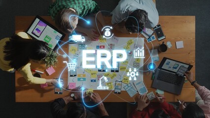 A diverse group of professionals collaborates on ERP solutions, utilizing laptops and notes on a table, showcasing innovative strategies and technologies through digital elements. Raster