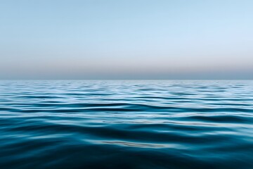 Obraz premium Serene water surface at blue hour, reflecting soft ripples and tranquil hues, creating a peaceful ambiance with copy space for design and creative projects