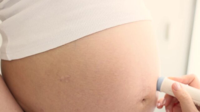Close up of ultrasound scan of pregnant woman in third trimester in medical clinic